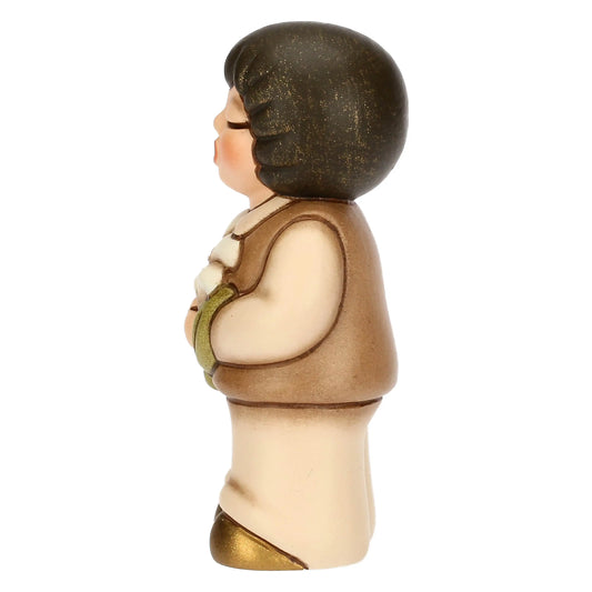 Bimbo in ceramica con giglio